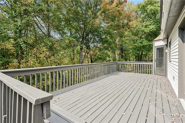 a balcony with wooden floor and fence