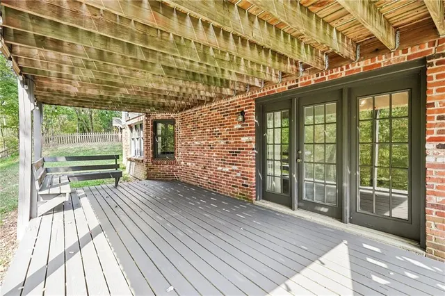 a view of outdoor space with wooden floor and windows