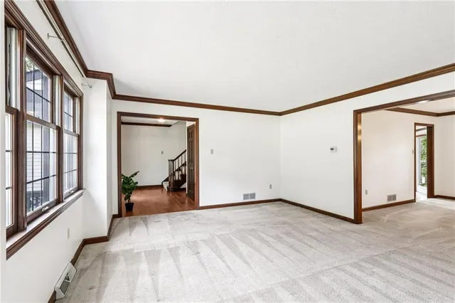 a view of a livingroom with wooden floor and furniture