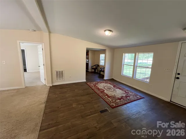 a living room with furniture window and a wooden floor