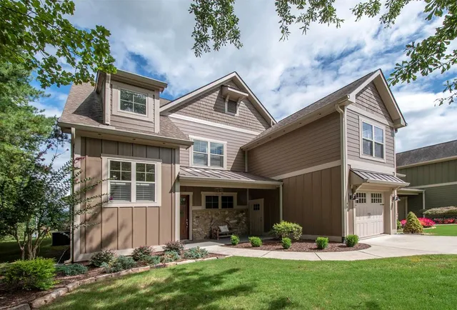 a backyard of a house with outdoor seating and a garden