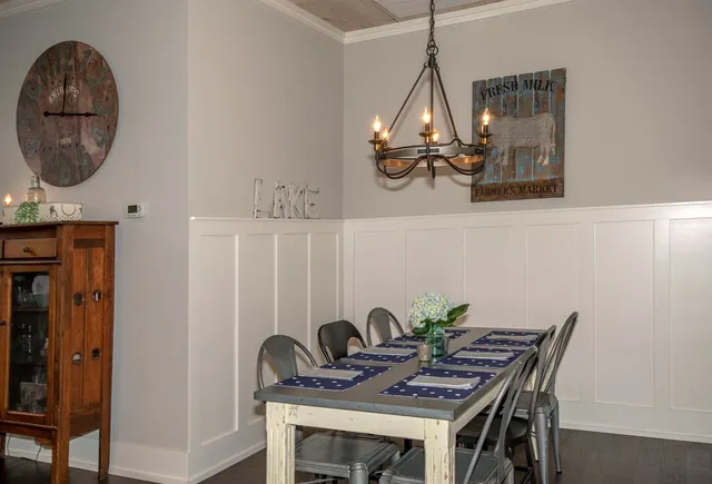 a view of a dining room with furniture wooden floor and chandelier
