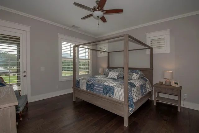 a bedroom with a bed and a ceiling fan