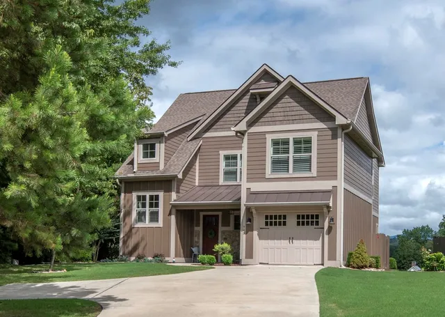 a front view of a house with a garden and plants