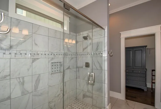 a bathroom with a granite countertop sink a toilet and shower