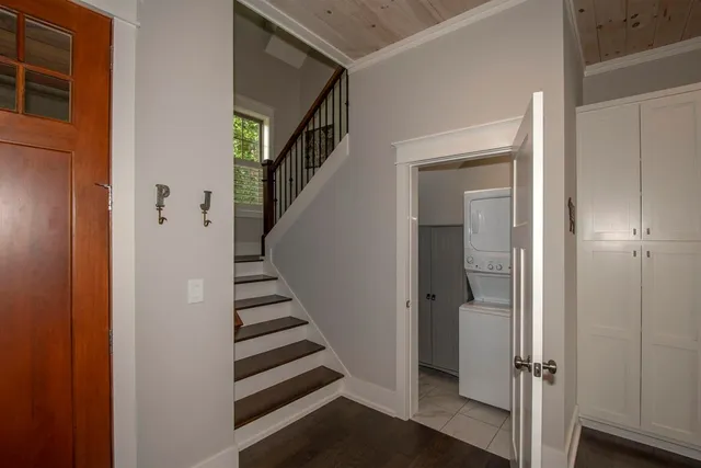 a view of a hallway with closet and stairs