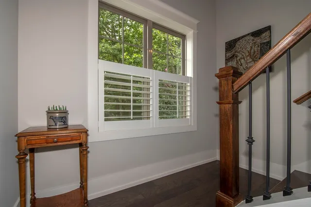 a living room with furniture and a flat screen tv with kitchen view