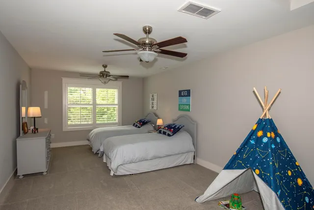 a bedroom with bed and a chandelier