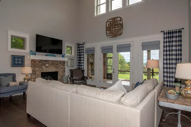 a living room with furniture a flat screen tv and a fireplace