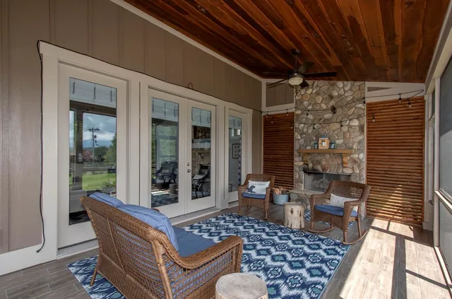 a living room with furniture a flat screen tv and a fireplace