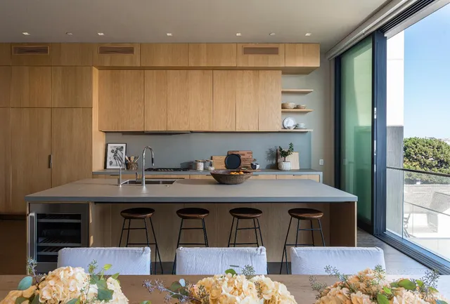 a kitchen with cabinets table and chairs