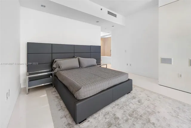 a bedroom with a bed and a cabinets