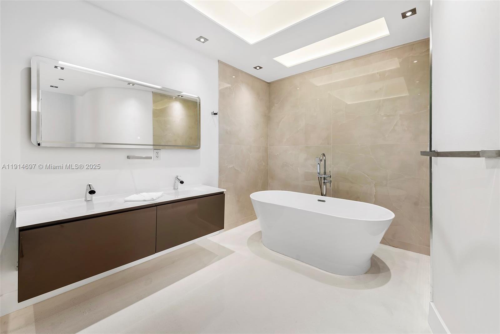 100 South Pointe Drive, Unit 2306 Miami Beach, FL 33139 - Photo 14 of 17 a bathroom with a bathtub a mirror a sink and vanity