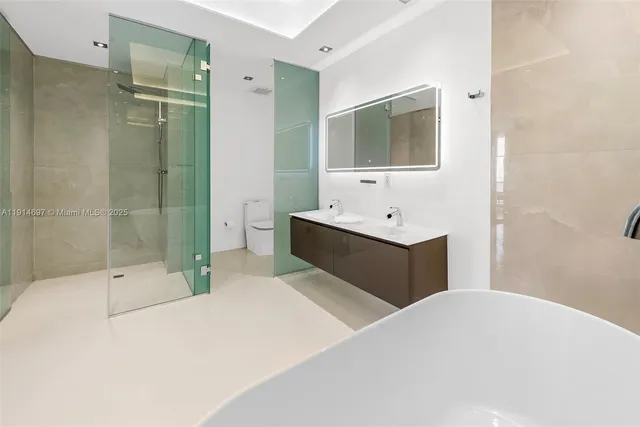 a en suite bathroom with a double vanity sink a mirror and a shower