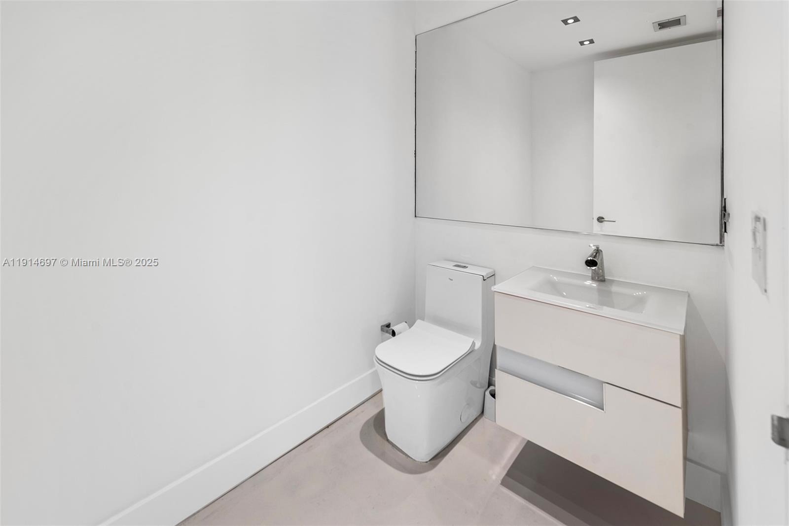 100 South Pointe Drive, Unit 2306 Miami Beach, FL 33139 - Photo 7 of 17 a bathroom with a toilet sink and mirror