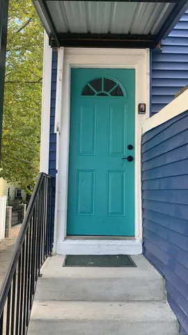 a front view of a house with a green gate