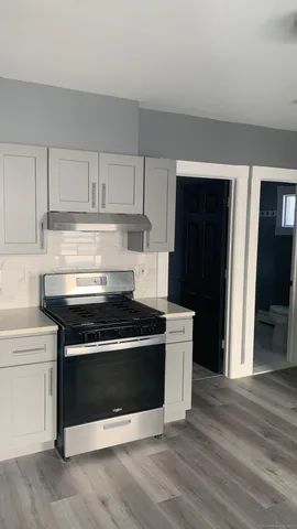 a kitchen with stainless steel appliances granite countertop a stove and a refrigerator