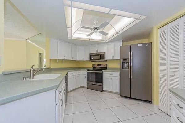 a view of a kitchen with a cabinet and a chandelier