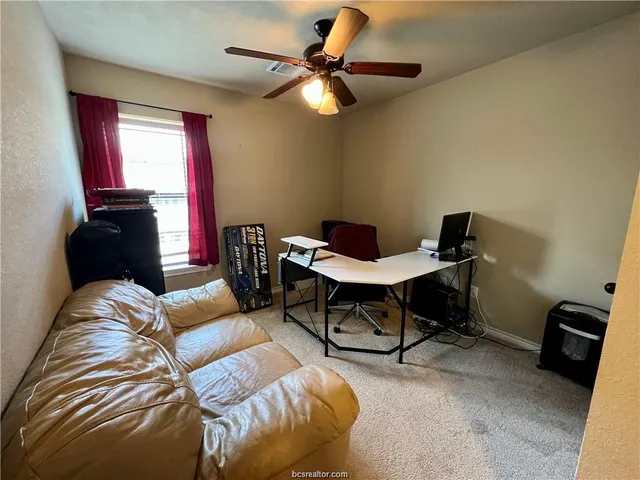 a living room with furniture rug and a window