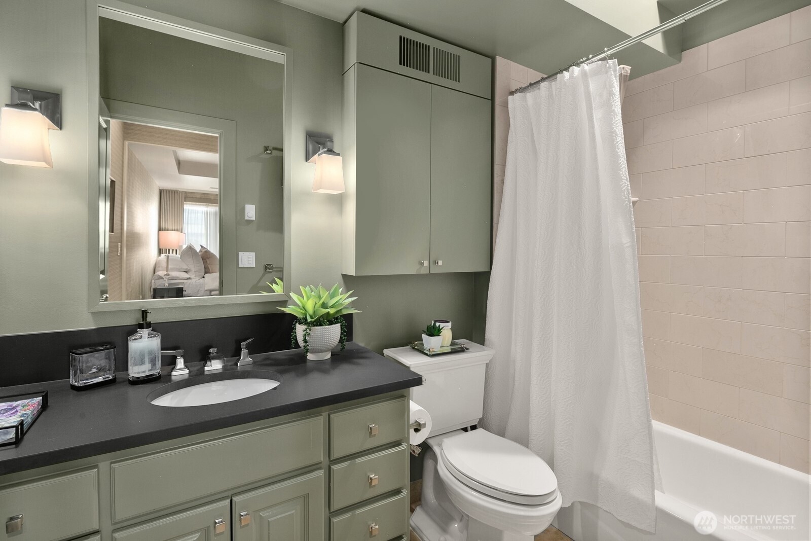 505 West Mercer Place, Unit 101 Seattle, WA 98119 - Photo 18 of 24 a bathroom with a granite countertop sink a toilet and a mirror