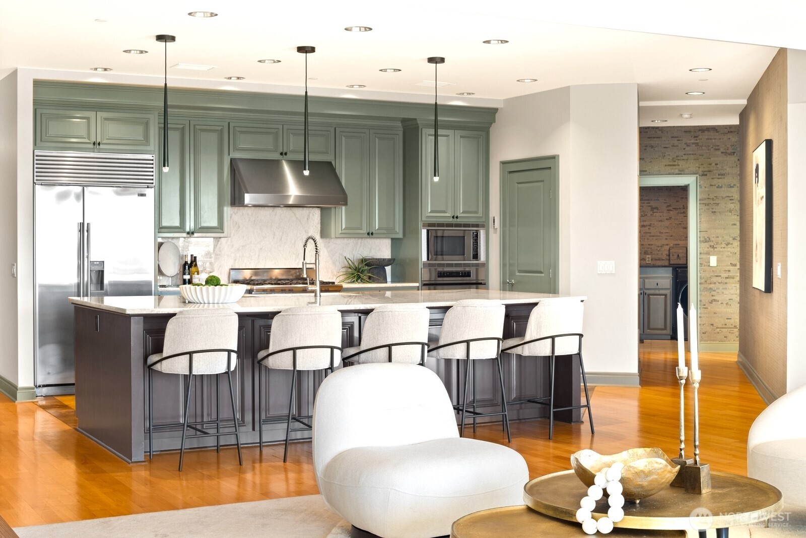 505 West Mercer Place, Unit 101 Seattle, WA 98119 - Photo 6 of 24 a kitchen with stainless steel appliances kitchen island granite countertop a table and chairs in it