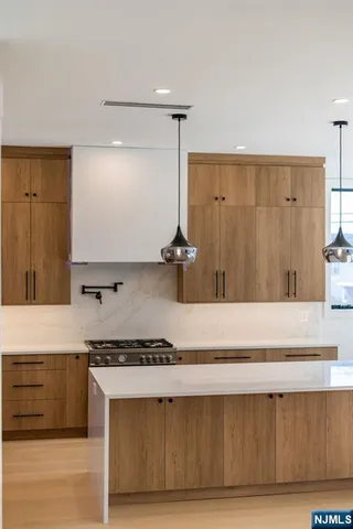 a kitchen with a wooden floor and cabinets