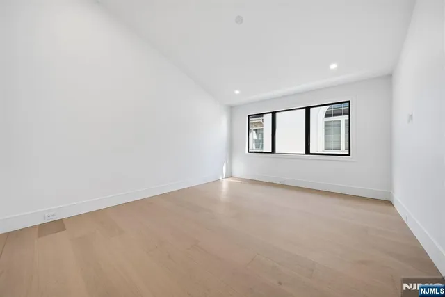 an empty room with windows and closet