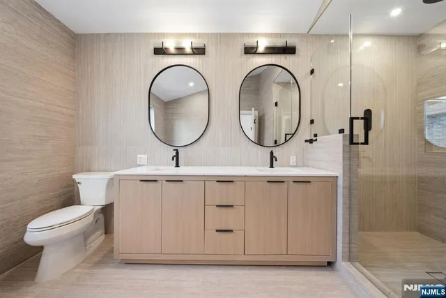 a bathroom with a toilet a sink and a mirror