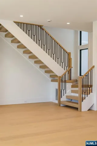 a view of an empty room with closet and a fireplace