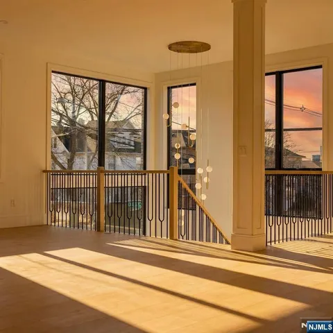 a view of staircase with railing and chandelier