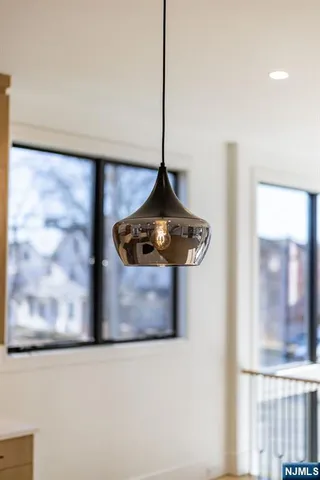 a room with wooden floor and a floor to ceiling window