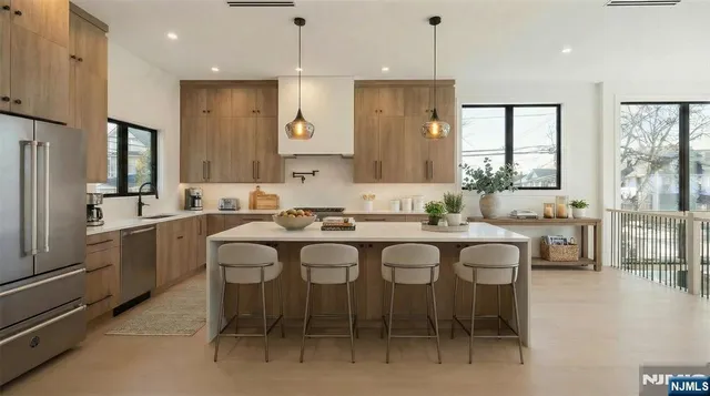 a large kitchen with a table and chairs