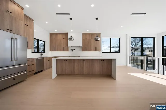 a large kitchen with stainless steel appliances kitchen island granite countertop a large counter top stainless steel appliances and cabinets