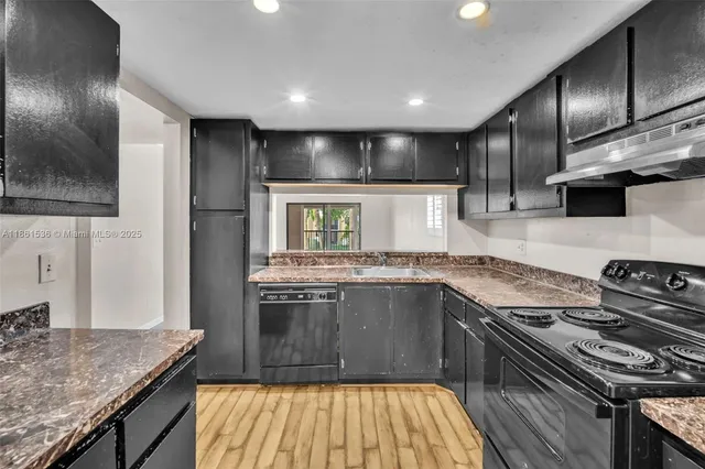 a kitchen with stainless steel appliances granite countertop a stove and a sink