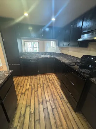 a view of kitchen with wooden floor