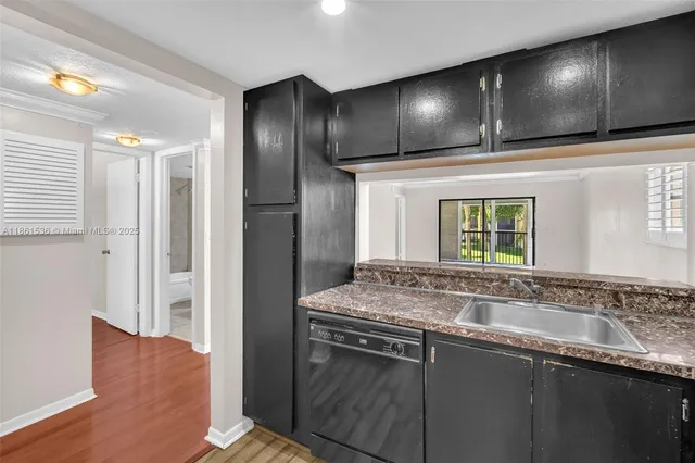 a kitchen with a refrigerator and a sink