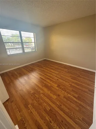 a view of wooden floor in an empty room