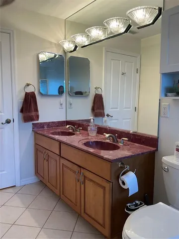 a bathroom with a stove a sink and a mirror