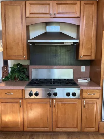 a stove top oven sitting inside of a kitchen