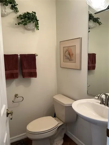 a white toilet sitting next to a bathroom sink