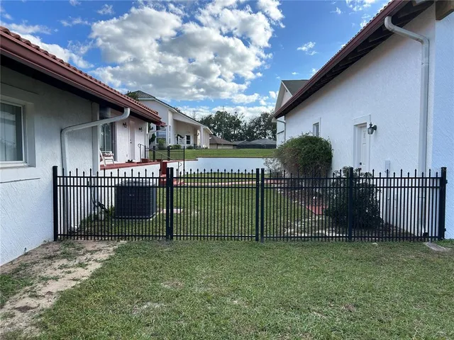 a view of a house with a backyard