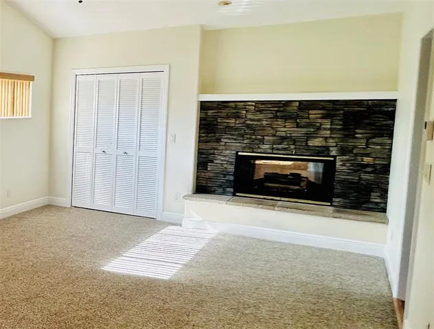 a view of empty room with a fireplace