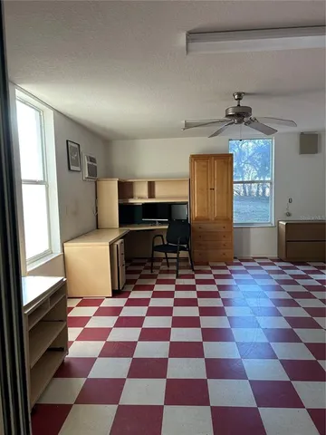 a view of a entryway in a hall with a rug