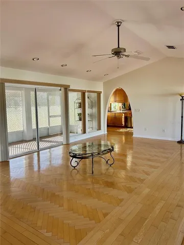 a living room with fireplace furniture and a floor to ceiling window
