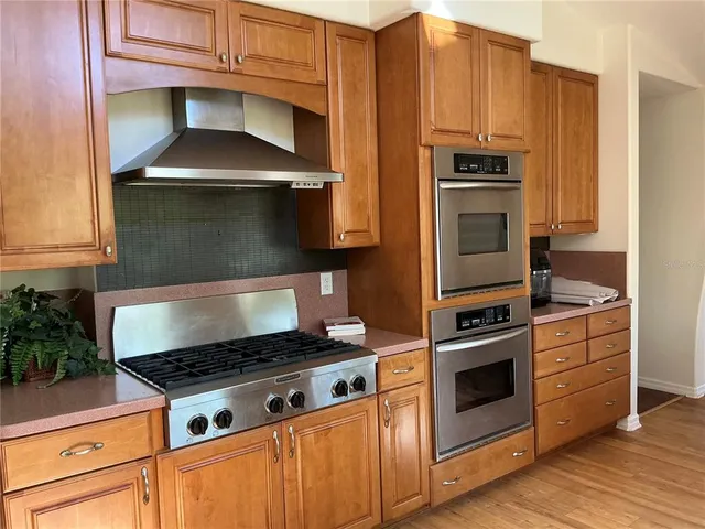 a stove top oven sitting inside of a kitchen