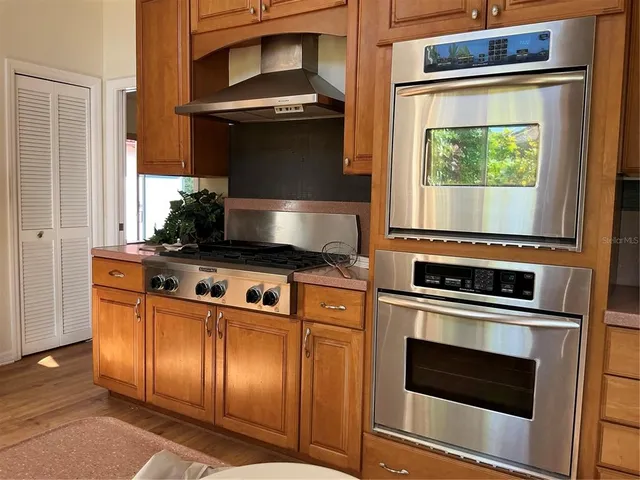 a stove top oven sitting inside of a kitchen