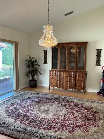a view of a room with window and wooden floor