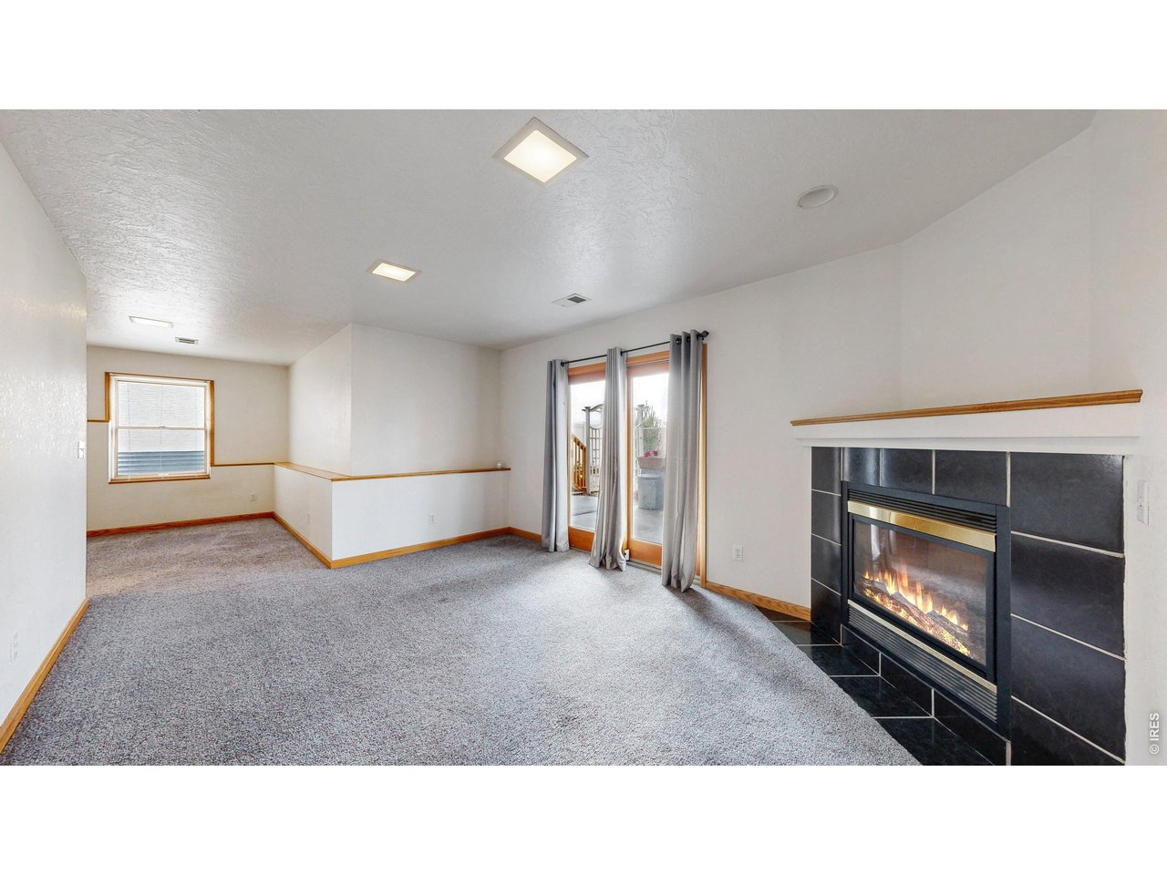 5017 West 6th Street Road Greeley, CO 80634 - Photo 36 of 42 Basement rec room and fireplace