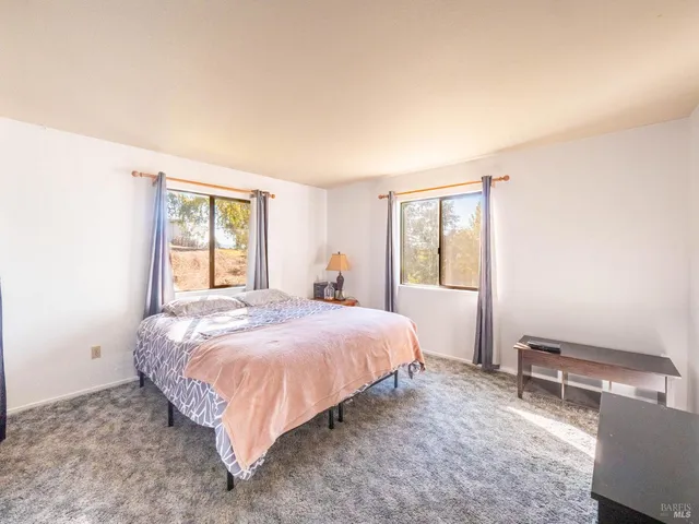 a bedroom with a bed and a table in it