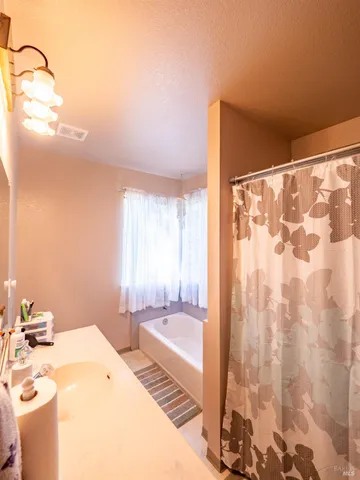 a front view of a house with a yard glass top table and chairs